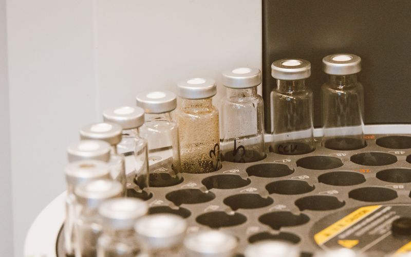 Glass vials arranged upright in a laboratory rack.